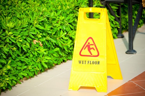 Caution Sign near wet walking area helps people avoid Slip and Fall Accidents.