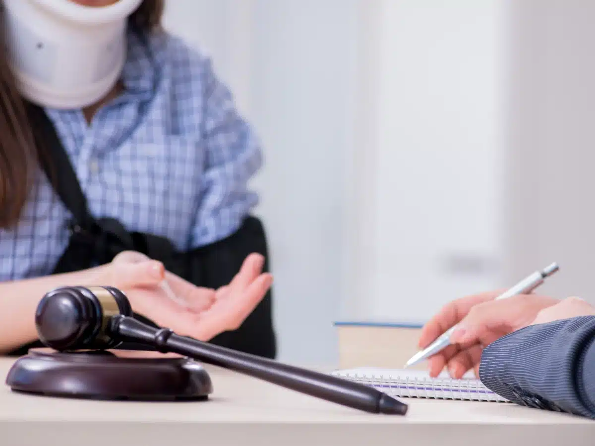 What is personal injury? Image of injured woman with neck brace hand out, Disparti Law Group