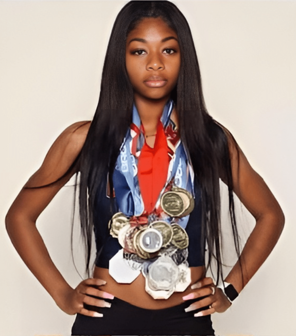 Image of Kyla Robinson-Hubbard wearing a large number of medals, Disparti Law Group