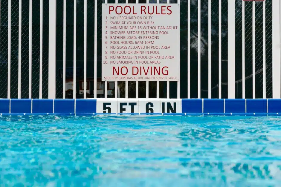 Swimming pool laws, image of swimming pool and pool rules posted above no diving, Disparti Law Group