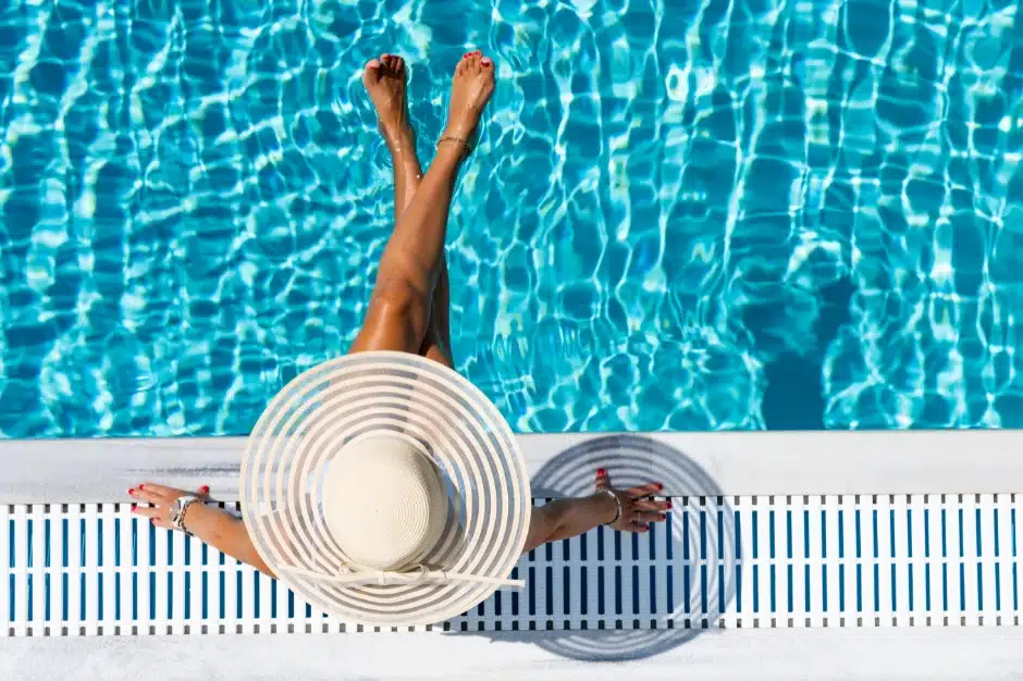 swimming pool laws in illinois, woman in hat sitting near pool pictured from above, Disparti Law Group