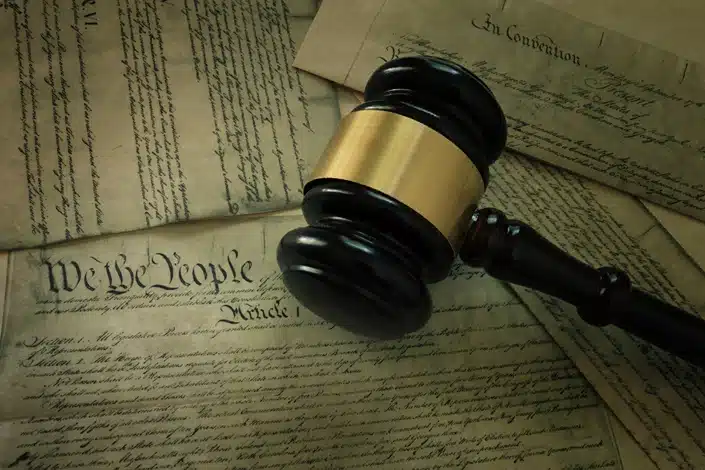 constitutional rights for public employees, image of gavel near papers reading "we the people" in old script, Disparti law group