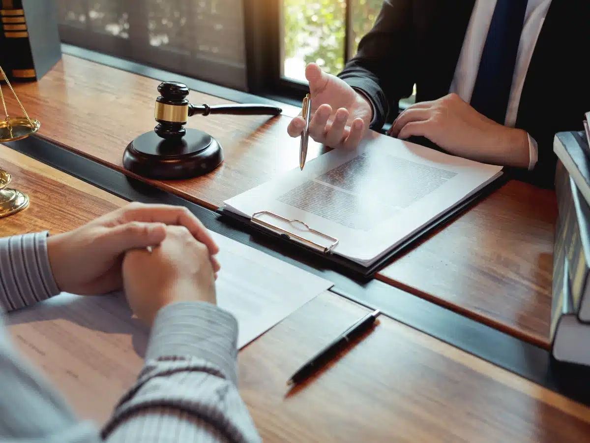 Denied disability a 2nd time, image of lawyer with client signing papers, Disparti Law Group