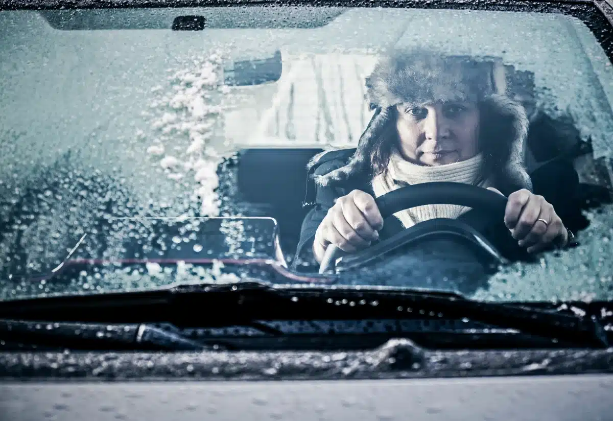 Winter driving, image of woman driving in car frosted windshield, Disparti Law Group 