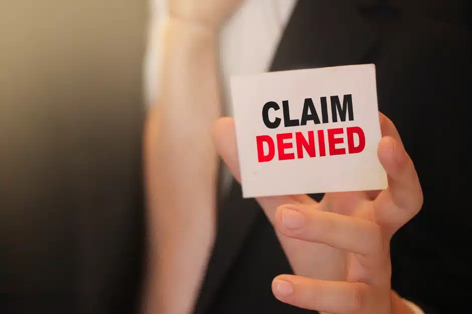 appeal a workers compensation decision, Disparti Law Group, image of someone holding card reading 'claim denied'